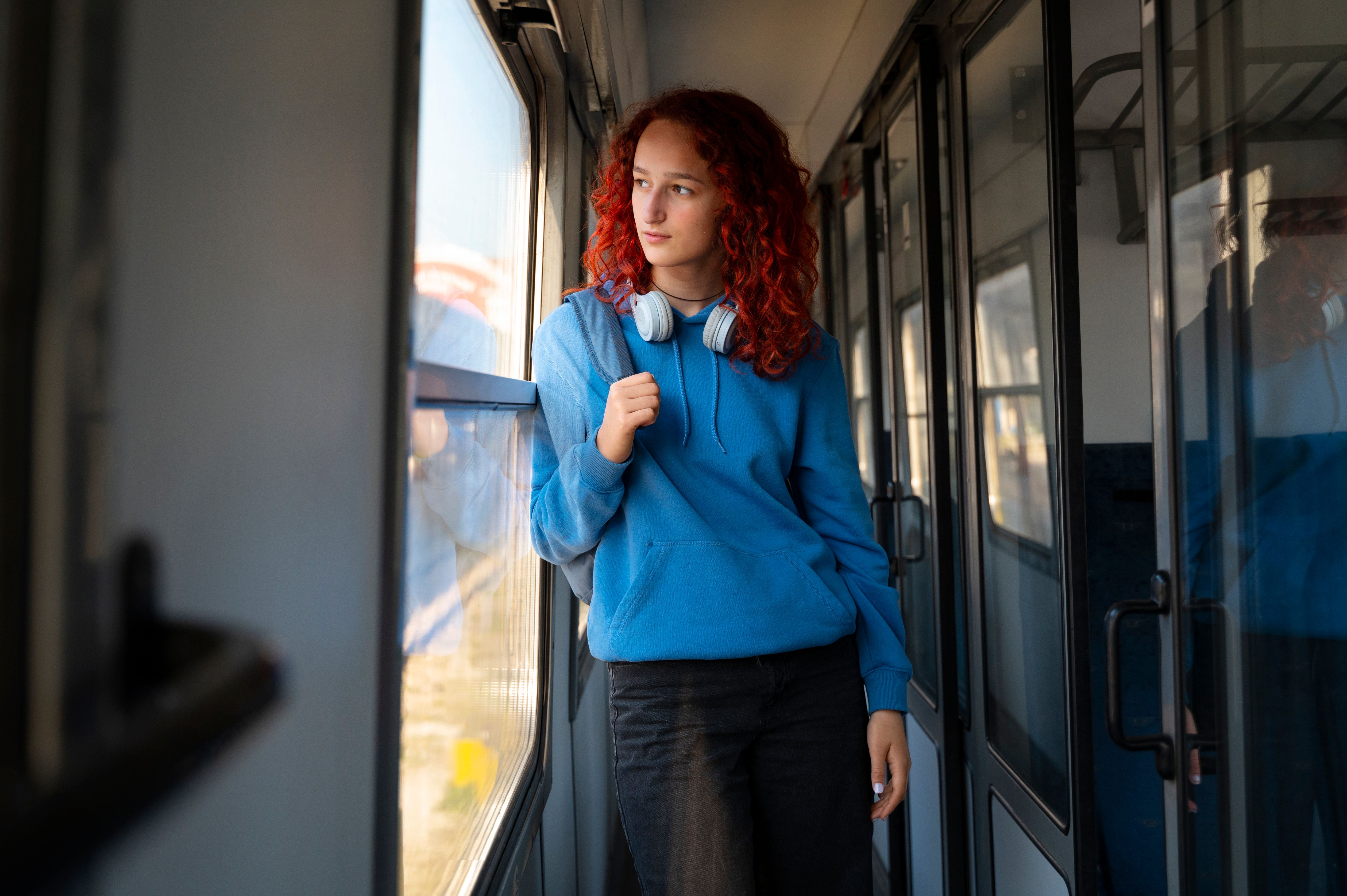 medium-shot-woman-traveling-by-train.jpg