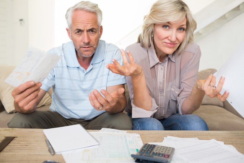 tensed-mature-couple-with-bills-calculator-home_13339-124534.jpg