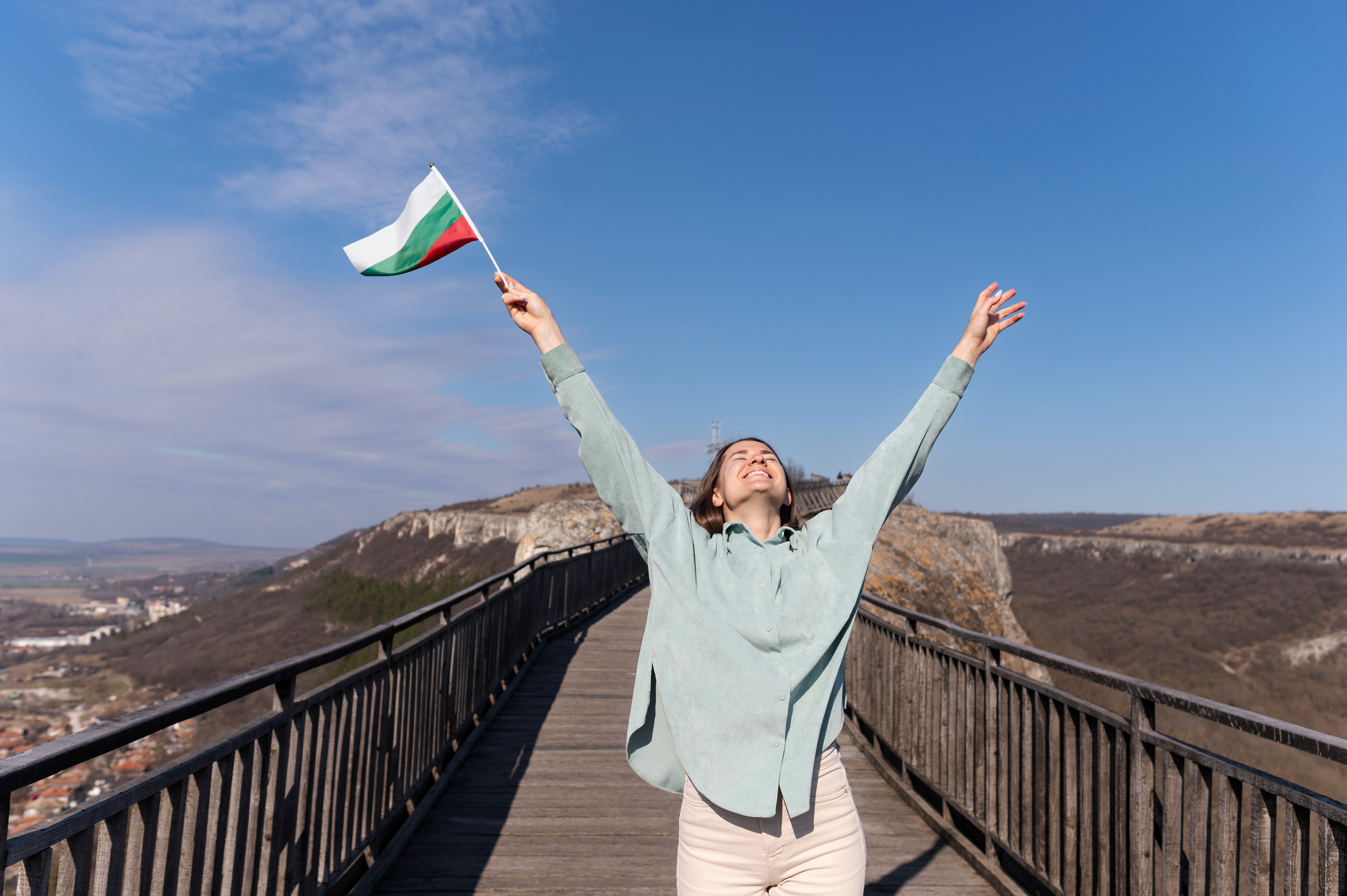 young-woman-outdoors-holding-bulgarian-flag.jpg